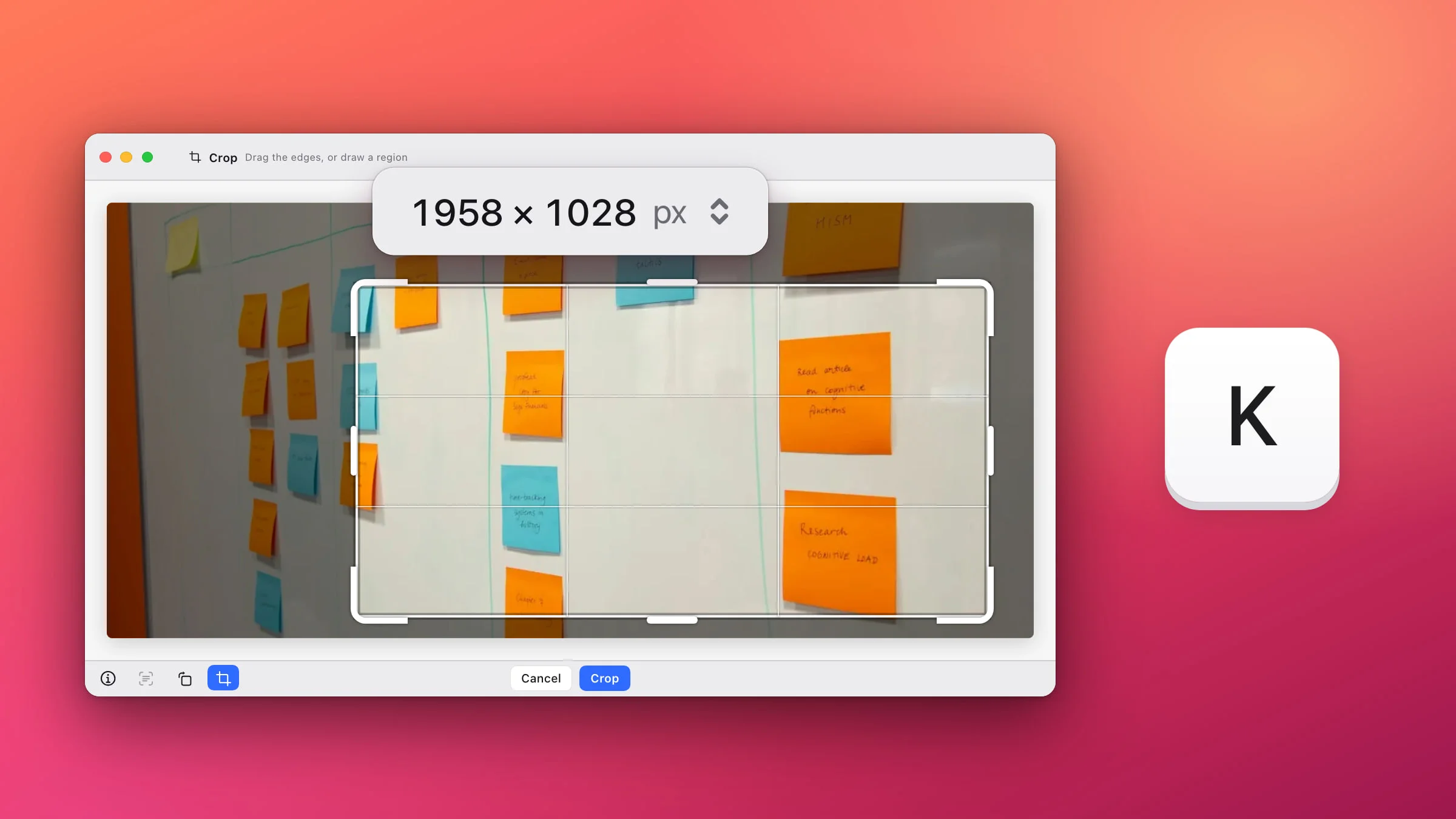 The Snapix editor in crop mode on a photo of a whiteboard covered in sticky notes: a frame with thick white corner handles and a thirds grid around most of the board, the rest of it dimmed, the size 1958 × 1028 px shown large under the top bar, Cancel and Crop in the bottom bar, and a large K key beside the window