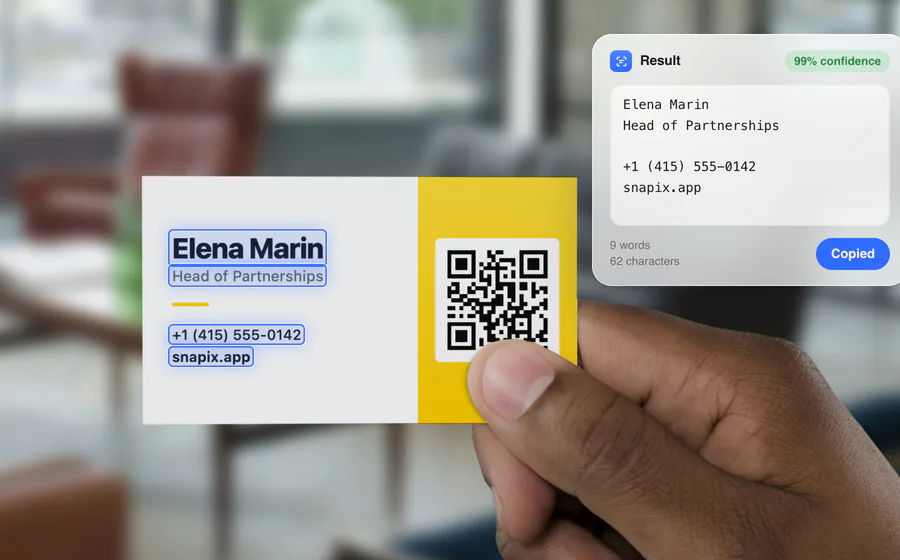 A hand holding a business card with each printed line framed as it is read, and beside it the result — Elena Marin, Head of Partnerships, +1 (415) 555-0142, snapix.app — at 99% confidence, with a Copied button